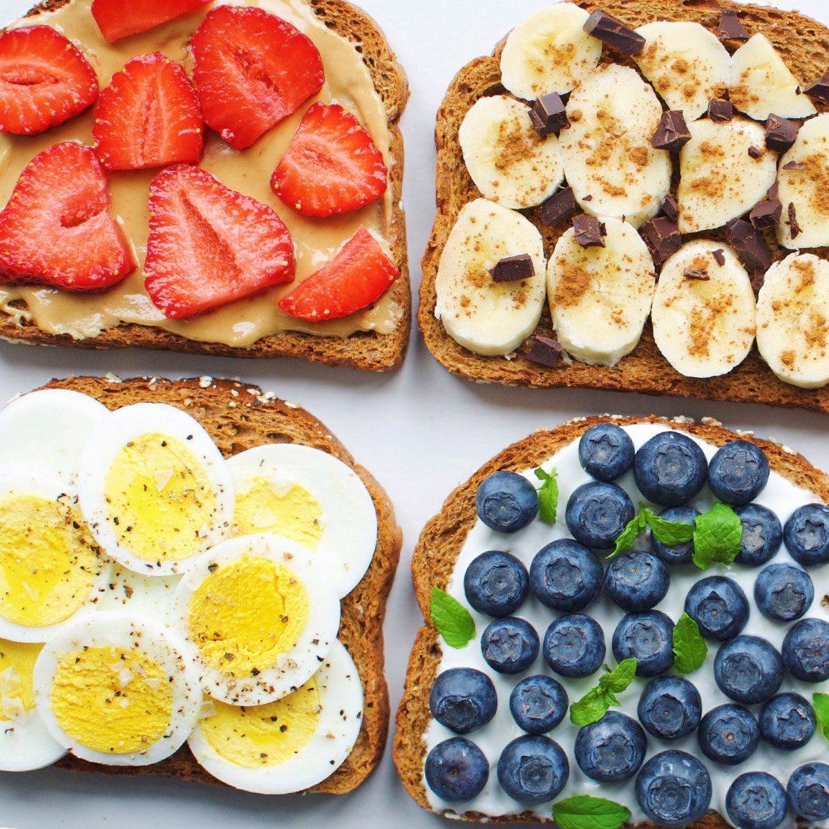 Toast with various ingredients including eggs, nut butters and fruit