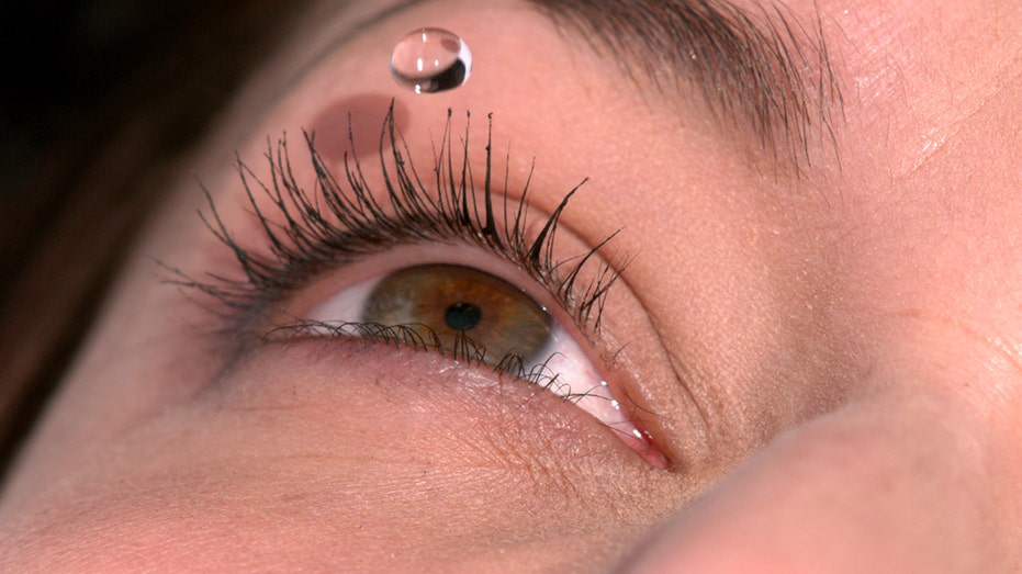 Woman using eye drops