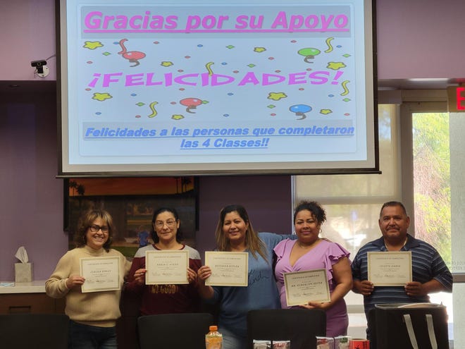 A proud group of newly diagnosed diabetic patients celebrate the end of their 16-hour Spanish course on living with diabetes.